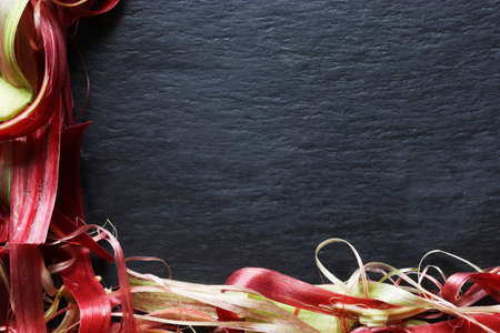 Photography of rhubarb waste on slate background for menus, labels or signsの写真素材