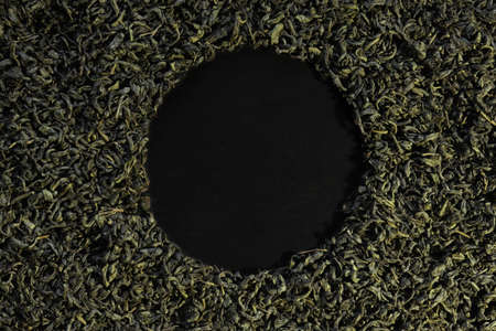 Photography of green tea leaves on slate background for menus, labels or signsの写真素材