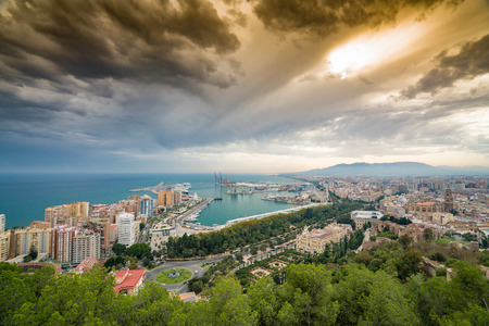 malaga port and malaga city with cathedral against a dramatic sky with clear blue seaのeditorial素材