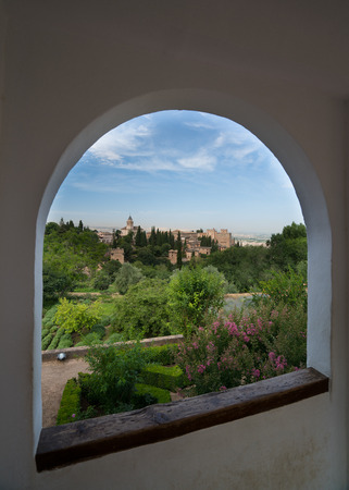 View throuh an arched window of Granada and the Alhambra Palace and fortress located in, Granada, Andalusia, Spain.の写真素材
