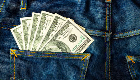 The dollar banknotes in jean back pocket