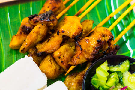 Chicken satay with compact rice and atjarの写真素材