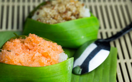 Sticky rice dessert with topping in banana leaf