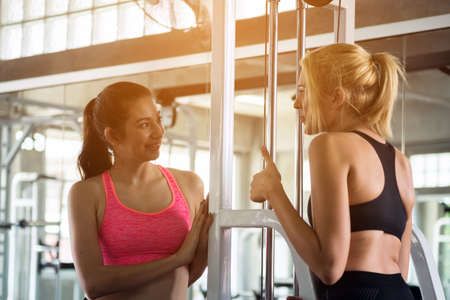 Two young woman discuss in the gymの写真素材
