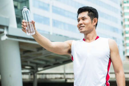 Man drinking water after running outdoor sportの写真素材