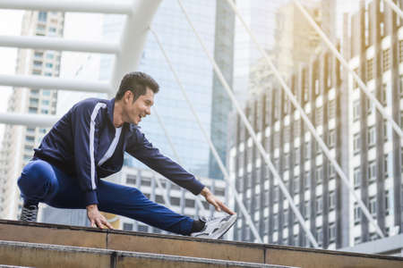 A man stretching before excercise at the outdoorの写真素材