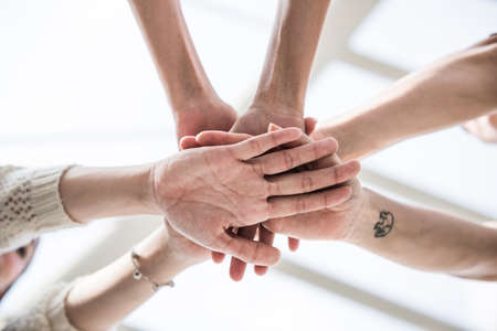 Friends join hand togetherの写真素材