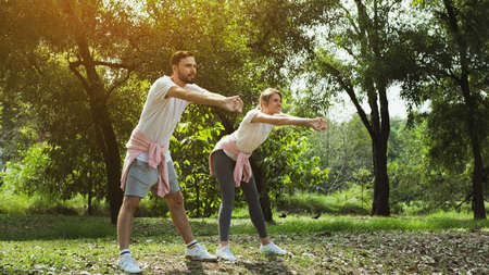 Young couple stretching at the park in the morining
