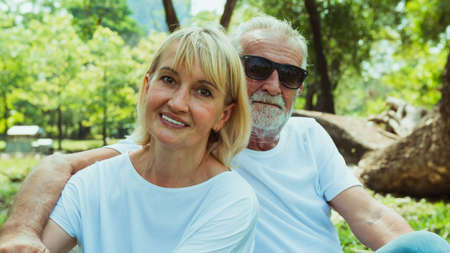 Happy Senior couple sitting in the park, retirement conceptの写真素材