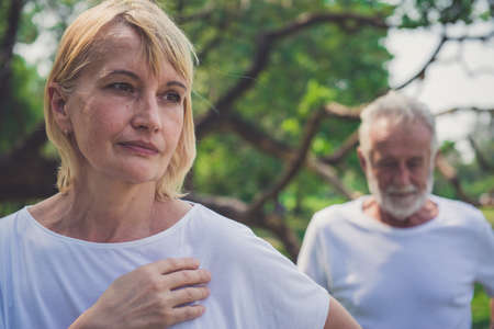Senior woman feeling depressed after having a argument with her husband outdoorの写真素材