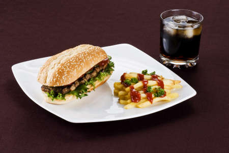 Ribeye steak in sesame seed bun with fries and cola