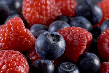 Closeup of fresh blueberries and raspberries mixed toghether
