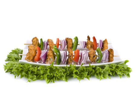 Skewers with chicken and vegetables on the plate - isolatedの写真素材