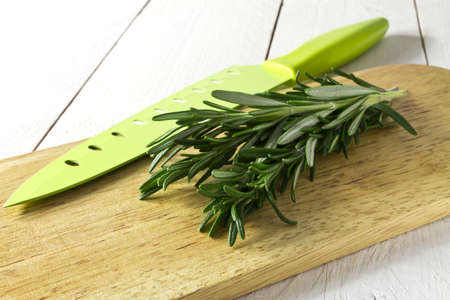 Fresh rosemary on chopping boardの写真素材