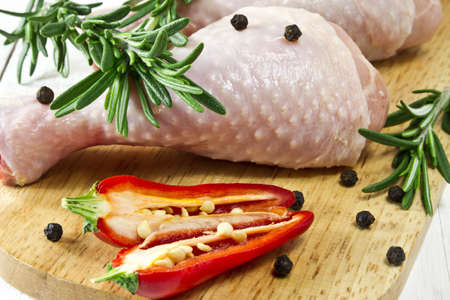 Fresh - raw chicken drumsticks on chopping boardの写真素材