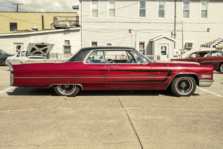 long old red and black car at a car showのeditorial素材