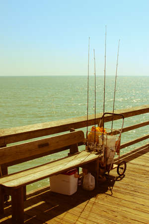 Fishing gear on the Naples pier with the ocean in the backgroundの写真素材