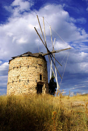 An old windmill in Ormylia (Halkidiki) on a cloudy day in July.の写真素材