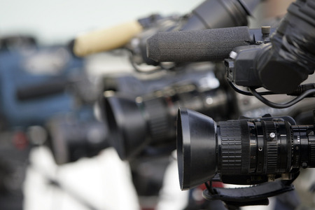 Line of cameras arranged for an interview.