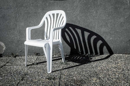 White chair with a powerful shade.の写真素材