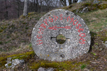 Large, old, round stone with inscription Hembyds museum.