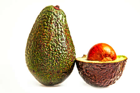 Avocado in beautiful colors with a shared avocado on the side. You see the beautiful core stick up...