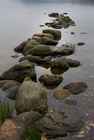 Stones on the beach at a lake.の写真素材