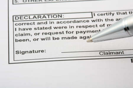 a declaration signiture is about to be signed on a binding documentの写真素材