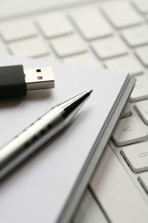 Ready to work with pen, pad, computer and usb stickの写真素材