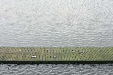 a pier or jetty with shoes left by swimmers or boatersの写真素材