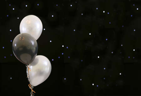 black and white party ballons with lights like stars, with copy space.の写真素材