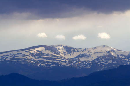 Mountain snow peak in carpathian with dramatic skyの写真素材