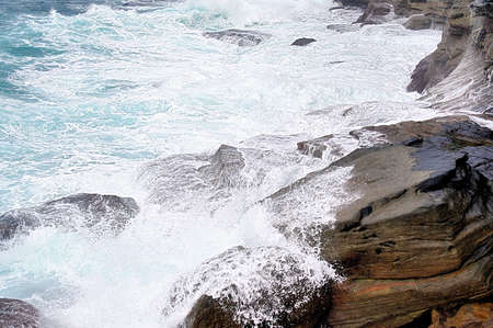 A view of the huge surf crashing on the cliffs on famous Bondi beach neighbour, Bronte Beach, neear Sydney, New South Wales, Australiaの写真素材