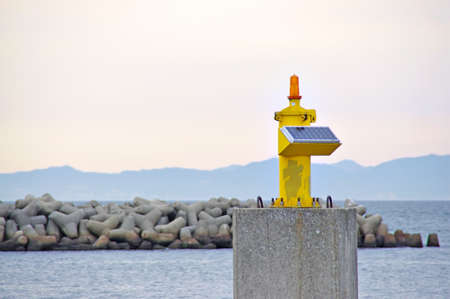 A yellow port entrance beacon fitted with a solar panelの写真素材