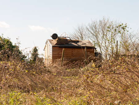 A glorious looking shed in the a grass fieldの写真素材
