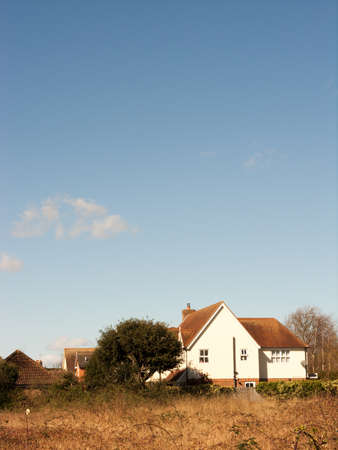 A house inn a beautiful field outbackの写真素材