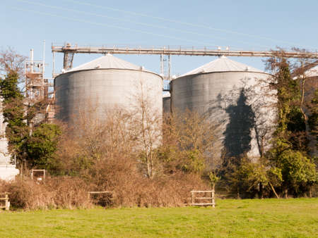 A close up shot of two towers of a factoryの写真素材