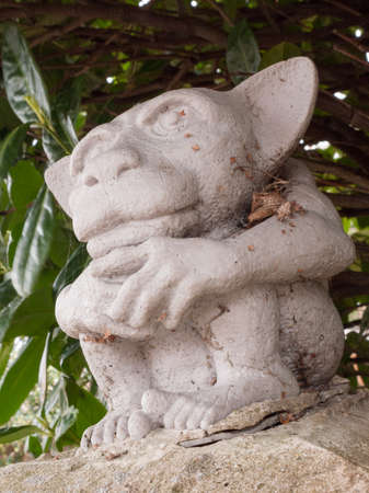 A creepy but funny little gremlin statueの写真素材