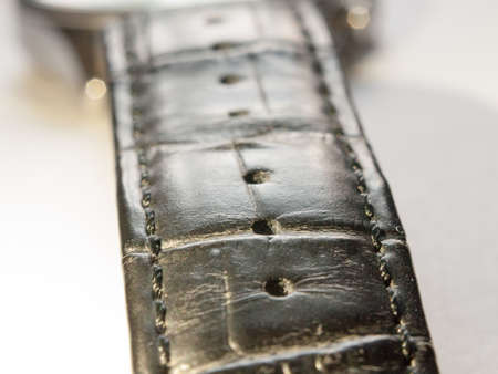 close up of black leather strap for watch on a white background macroの写真素材