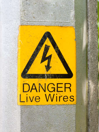 a yellow triangle with lightening bolt saying danger live wires graphic resourceの写真素材
