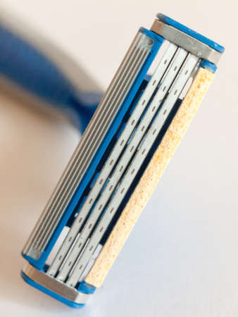 close up of new razor blade unused on white background