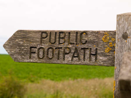 public footpath wooden sign outside leading way countryの写真素材