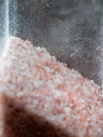 pink and white salt seen from the side inside glass; Essex; UKの写真素材