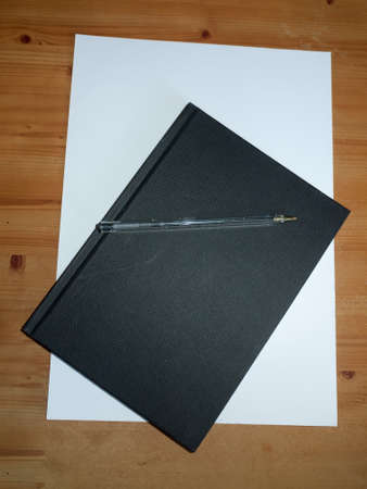 black desktop notepad with ball point pen for taking notes for studying and students; Essex; UK