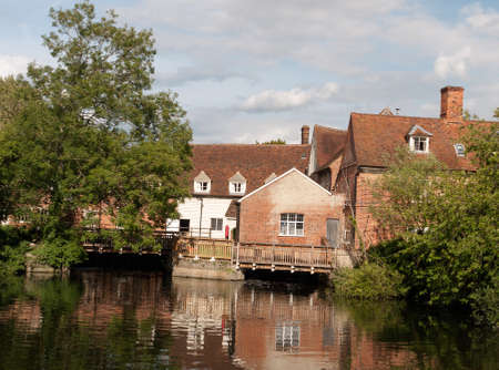 beautiful old historic buildings mill in england reflected in running river; UKのeditorial素材