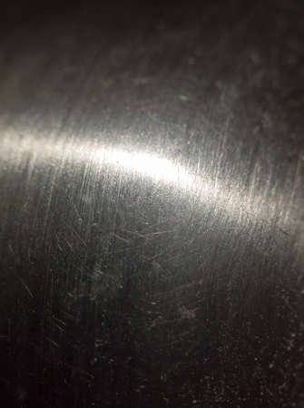 close up scratched metal surface with light across; UKの写真素材