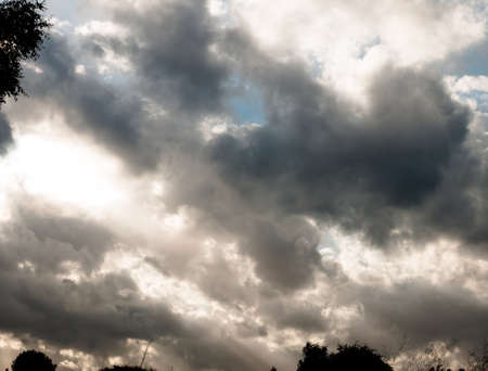 sky moody cloudy background with silhouette at bottom; UK