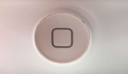 close up of white button on phone with square; UK