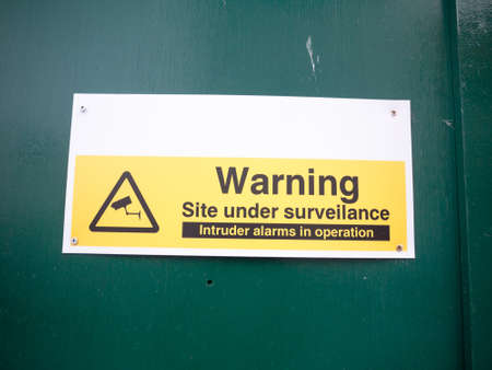 construction site warning site under surveillance cctv; England; UKの写真素材