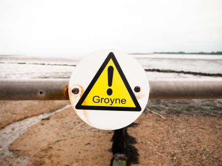 close up of exclamation yellow triangle groyne on metal poleの写真素材